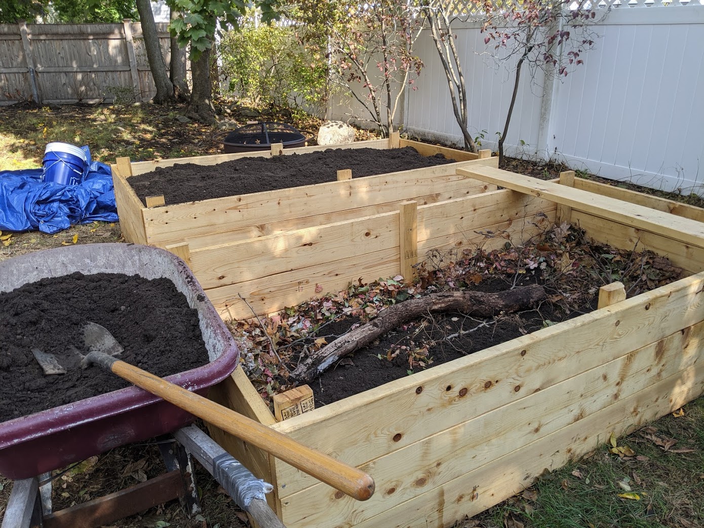 Two raised beds in the back yard, one filled, one partially filled with
woody debris